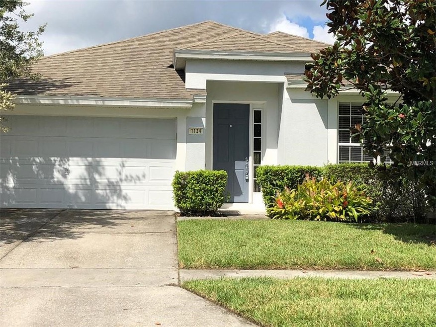Front of home with mature Magnolia tree.