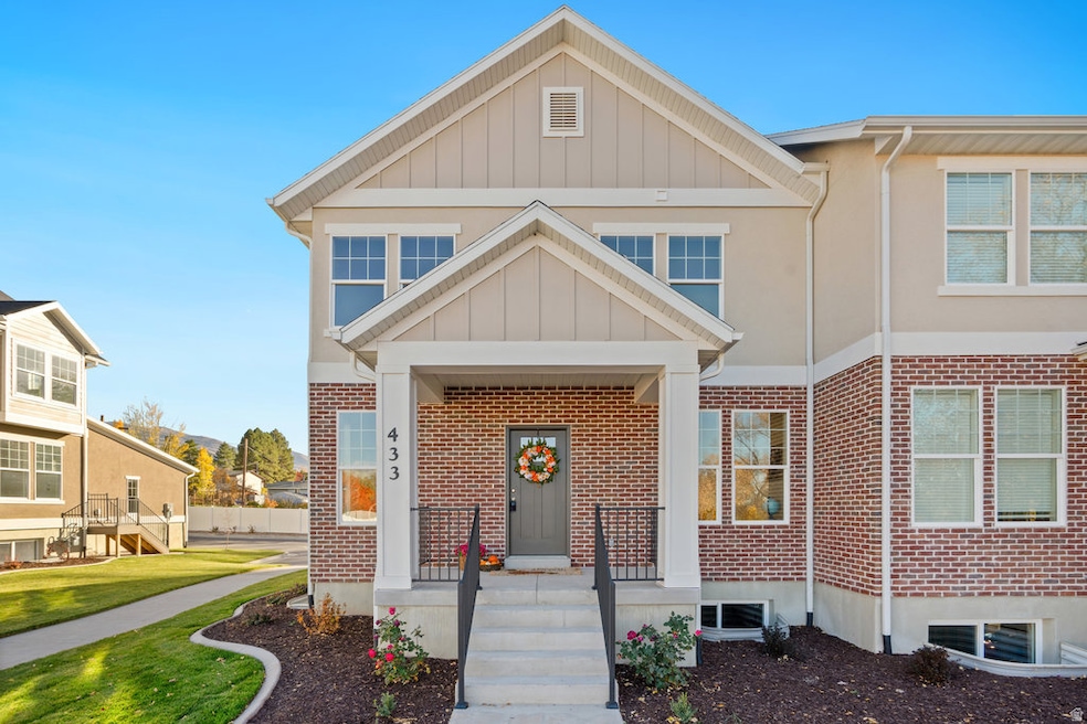 Craftsman-style house with board and batten siding, brick siding, and a porch