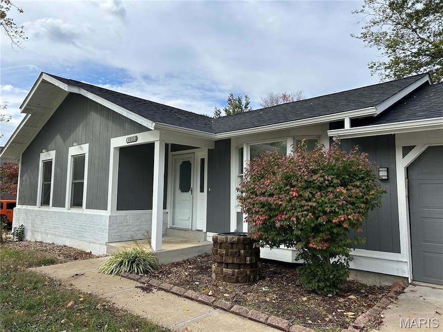Property entrance featuring roof with shingles, an attached garage, and brick siding