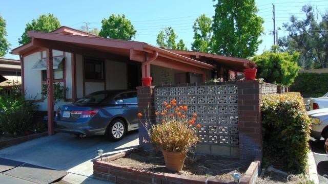 Street view with Covered Carport and Private Side 