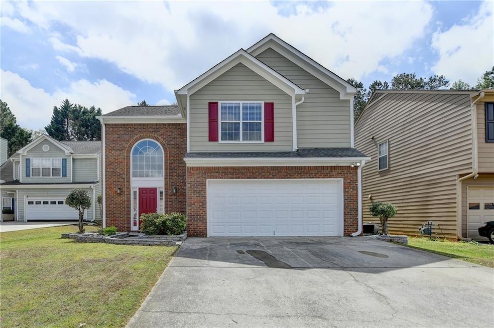 Traditional-style home with brick siding, driveway