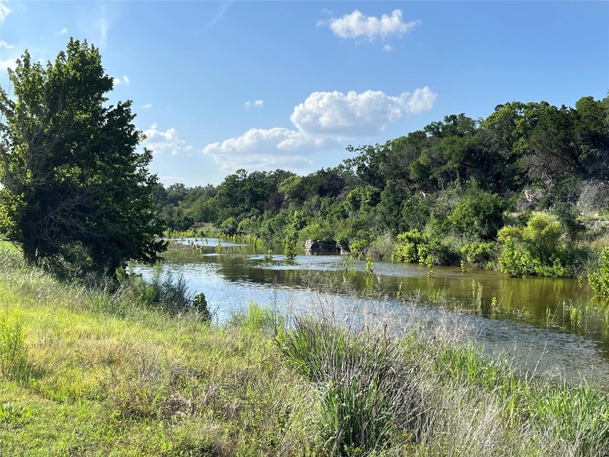 Water view with a heavily wooded area