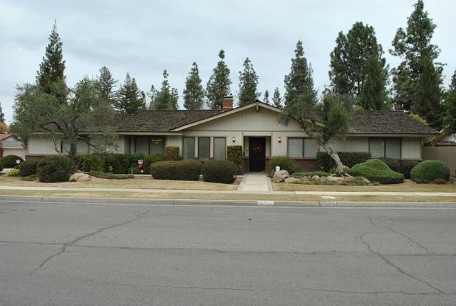Front of home with mature and well maintained land