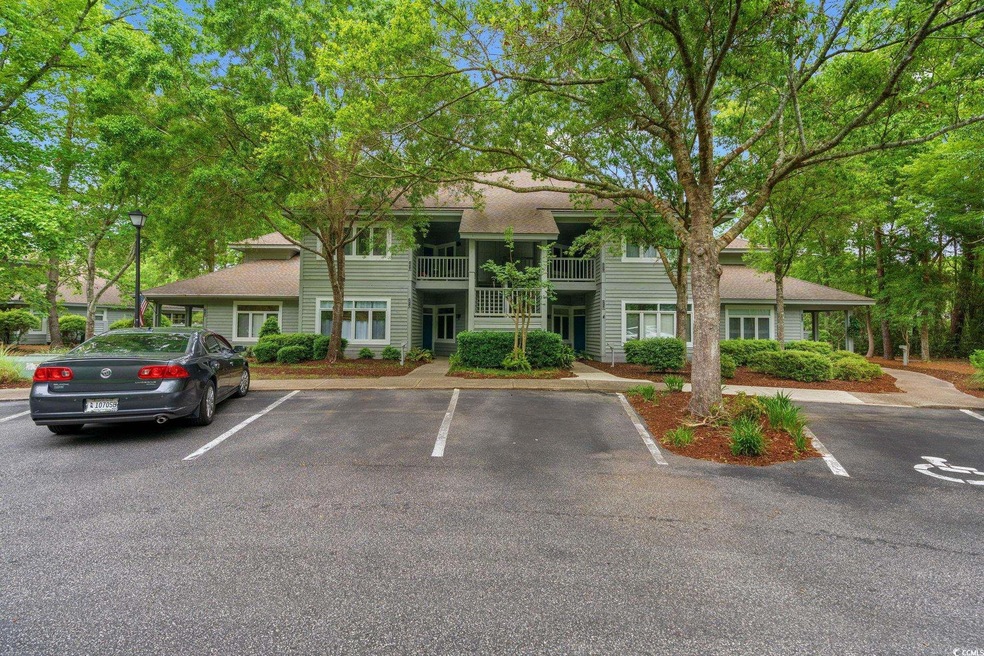View of property featuring uncovered parking