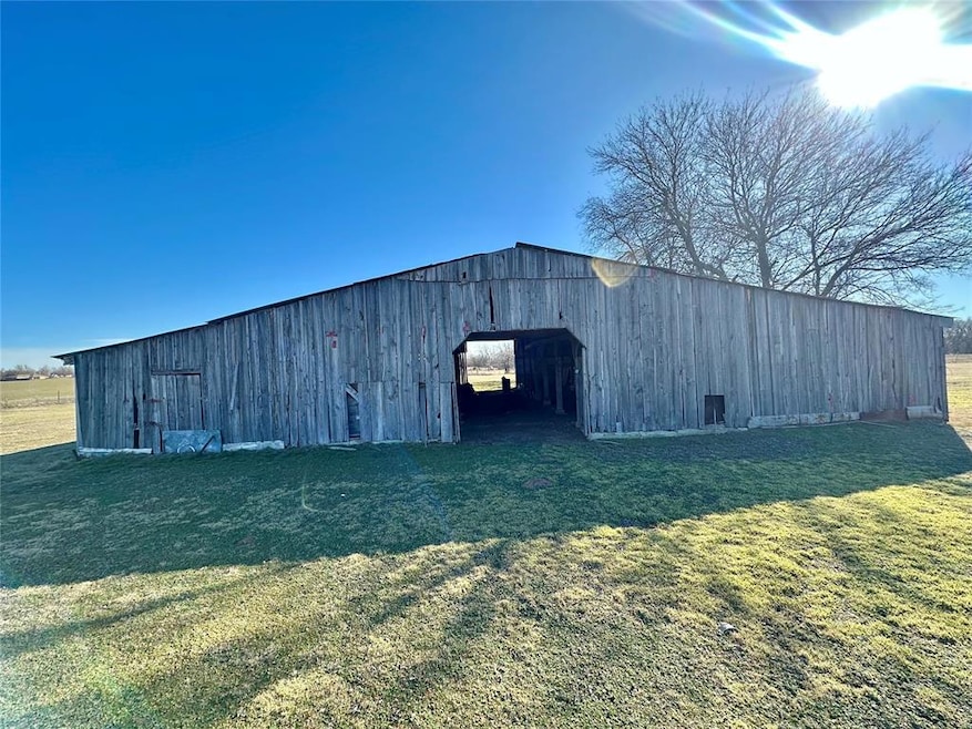 View of outdoor structure with a yard