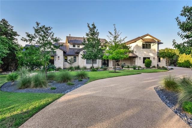 Curb appeal enhanced by the long, curving drive