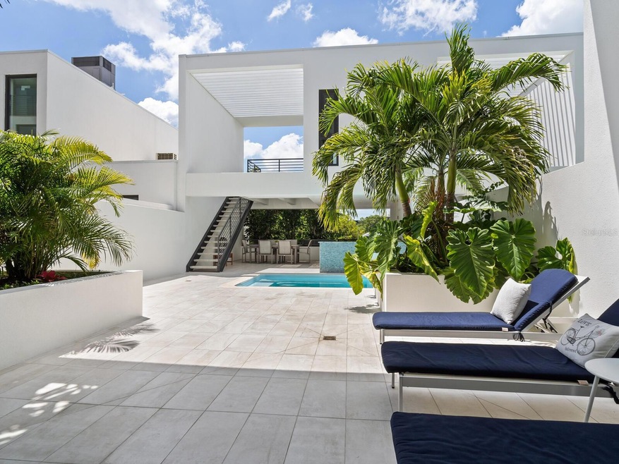 The stylish urban retreat at Zahrada I offers a relaxation lifestyle with alfresco summer kitchen and fire pit, and Florida's quintessential outdoor living.