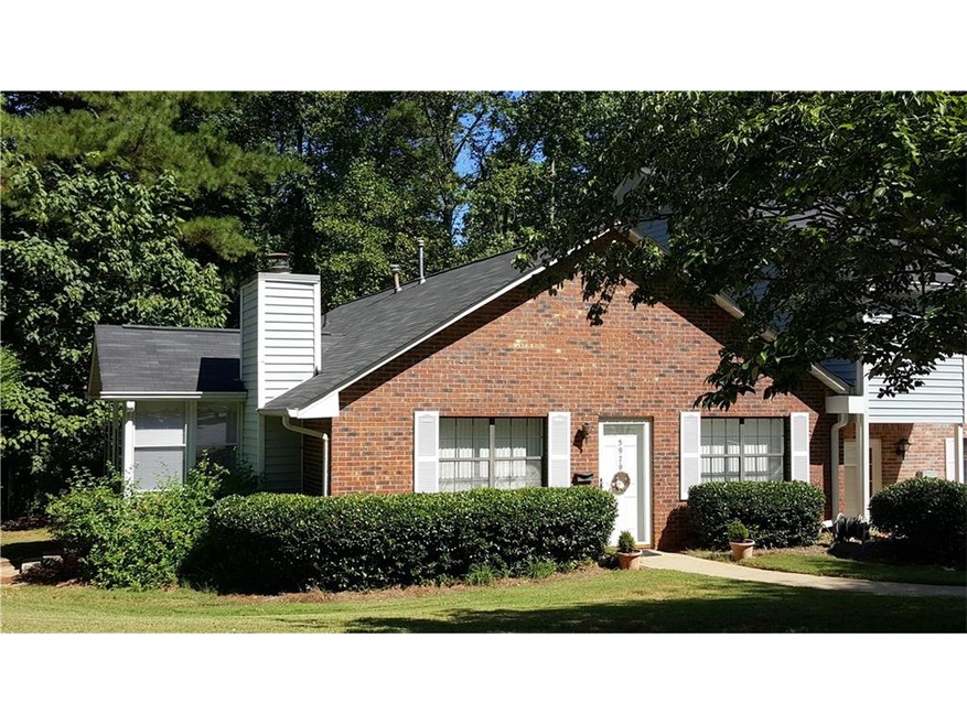 All brick end unit has enclosed sunroom and steple