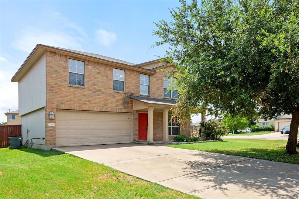 View of front of house featuring a garage, brick 