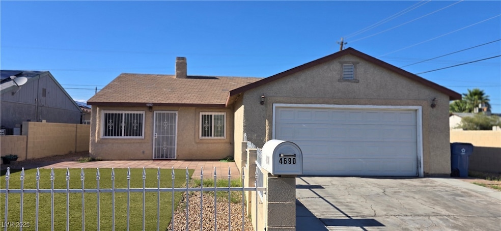 Ranch-style house with stucco siding, an attached