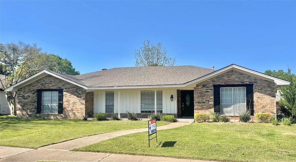 Ranch-style house featuring a front yard, a shingl
