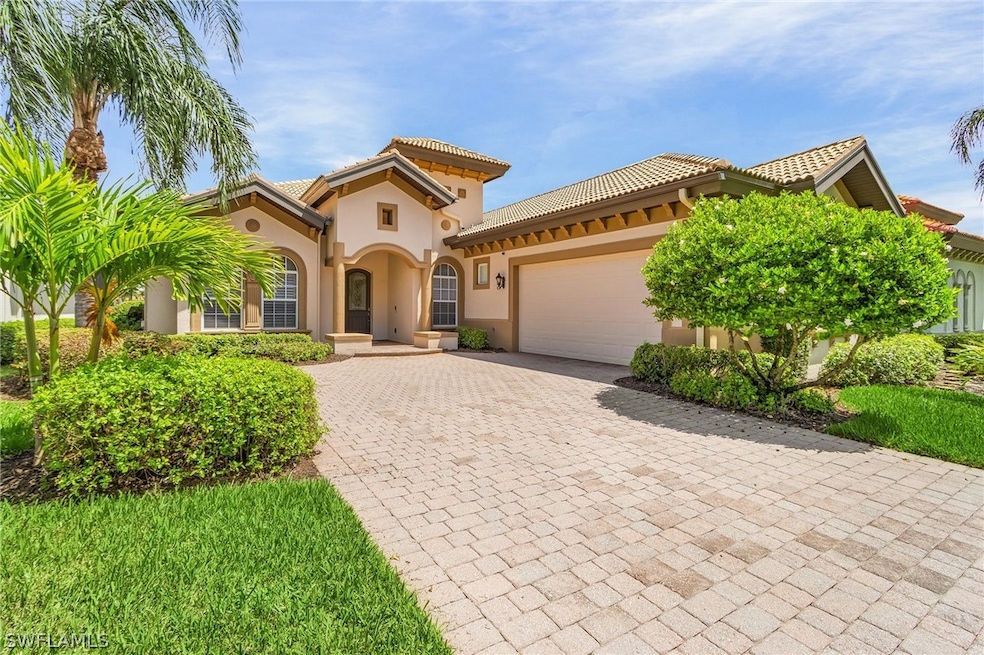 Mediterranean / spanish-style home featuring a gar