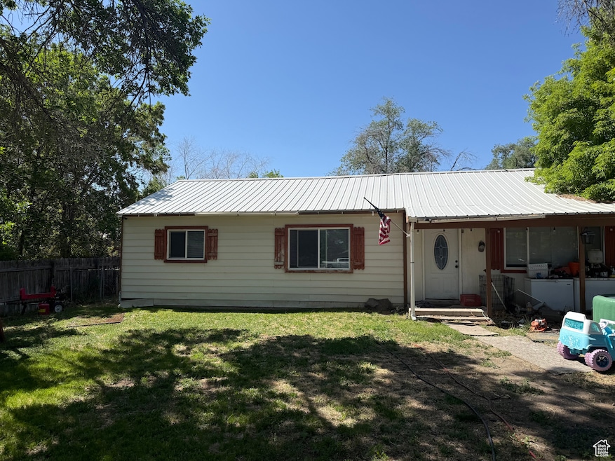 Ranch-style house with metal roof
