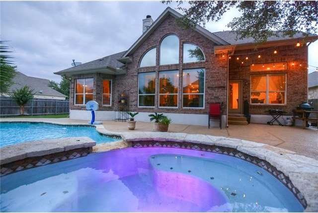 Backyard oasis feature in-ground pool with built i