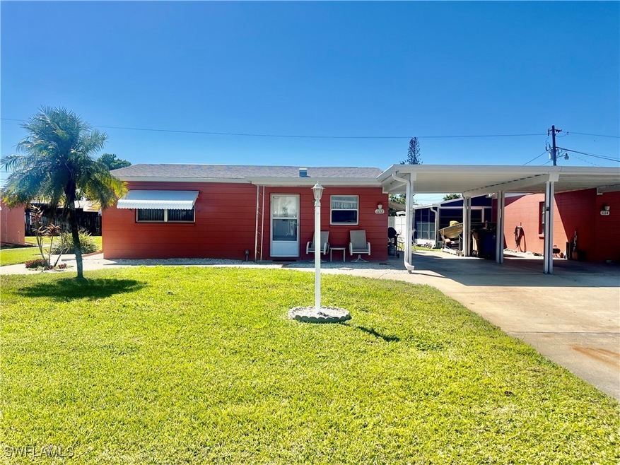 View of front of home featuring a carport, concret