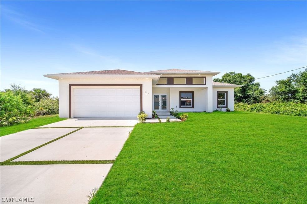 Prairie-style house featuring a garage and a front lawn