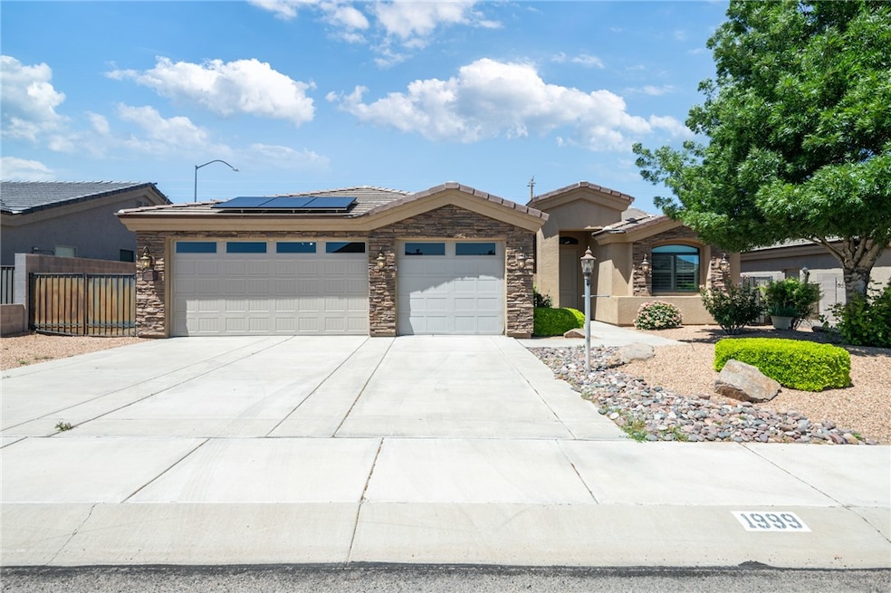 Ranch-style home featuring a garage, roof mounted
