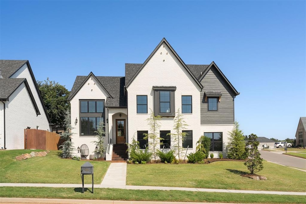 Front of home with stained concrete side patio and stained concrete steps up to the front door