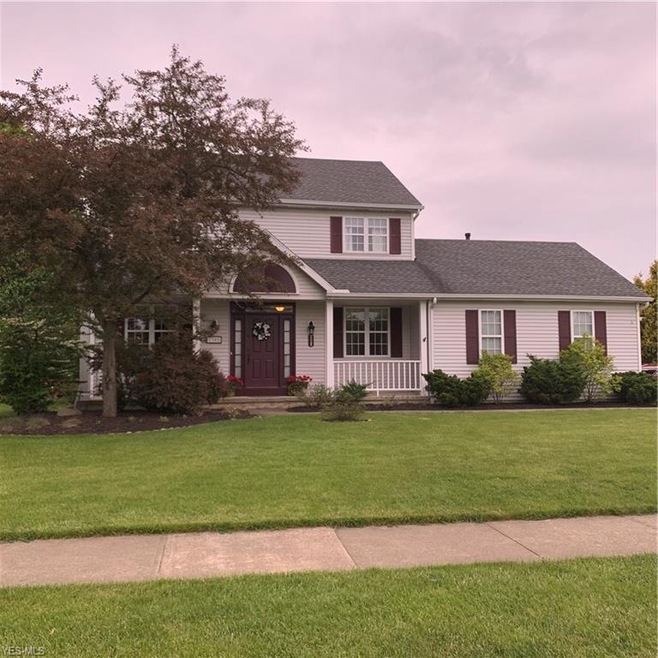Inviting entry with covered porch and side entry o