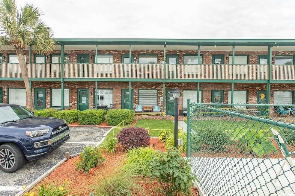 View of property with uncovered parking