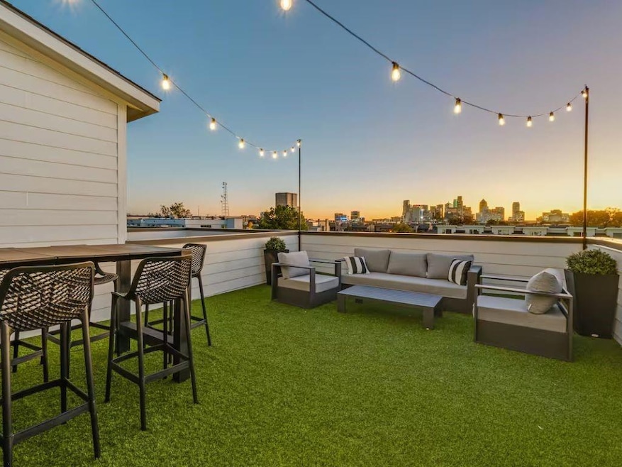 Yard at dusk with an outdoor living space and a ci