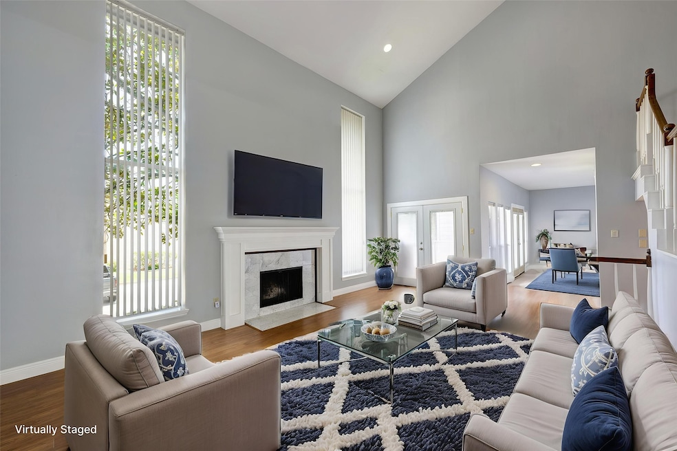 Large open living area with brick fireplace and 2 story ceiling