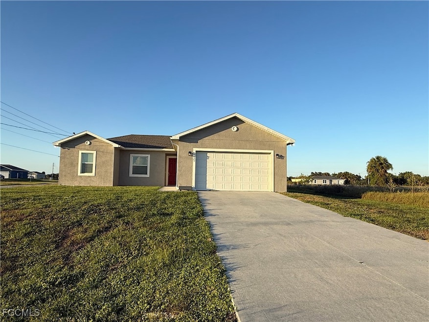 Ranch-style home with stucco siding, driveway, a front lawn, and a garage
