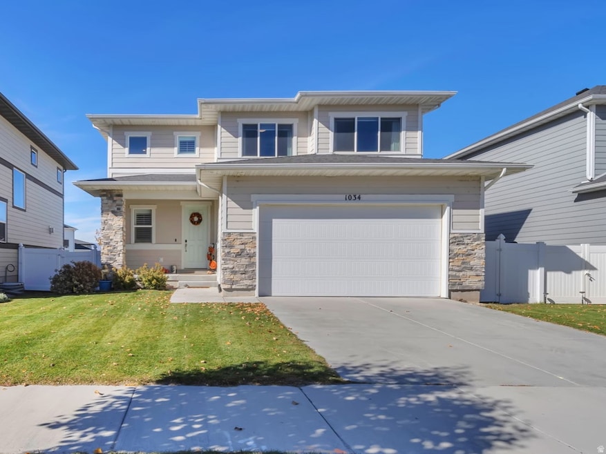 Traditional home with concrete driveway, stone siding, and an attached garage