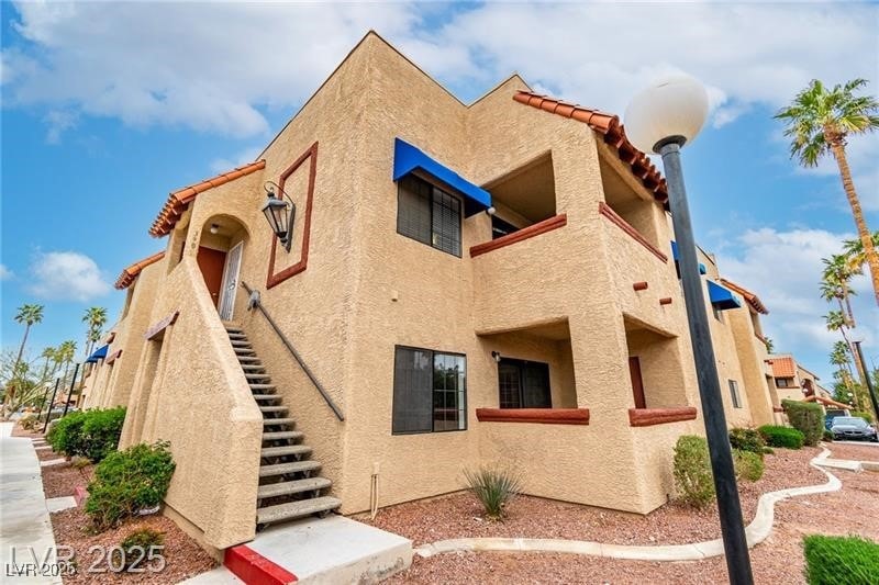 View of property with stairs