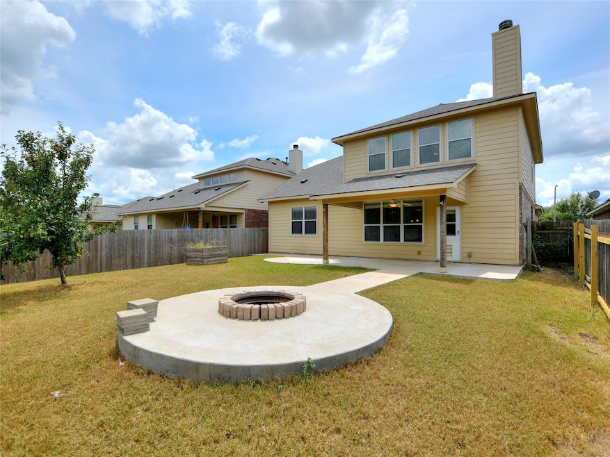 Back of property with a fenced backyard, a lawn, 