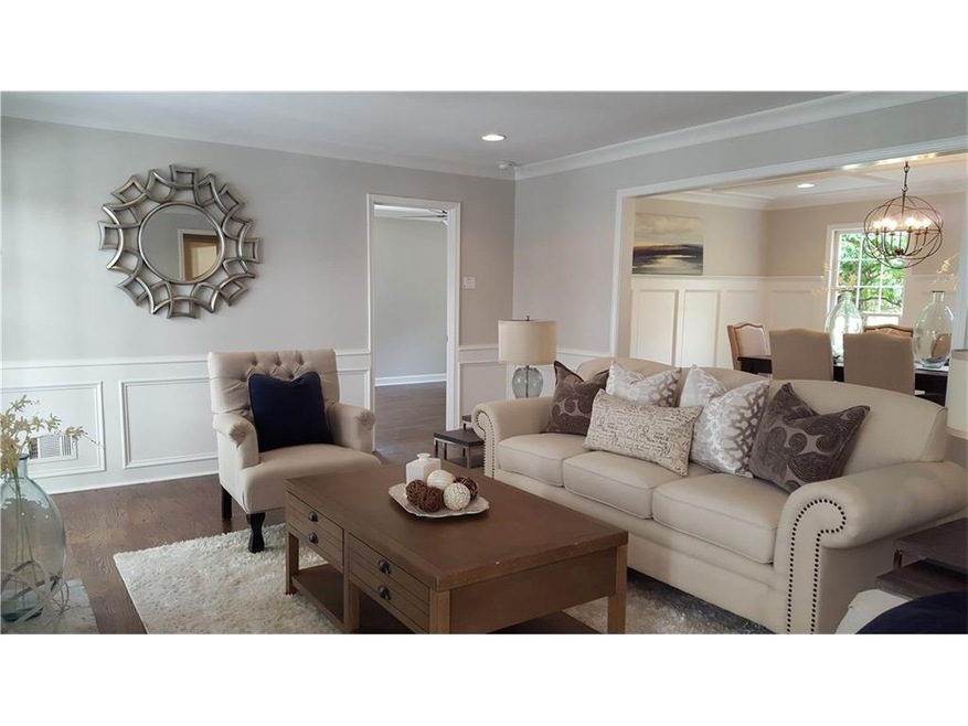 Light filled living room opens to deck with a perg