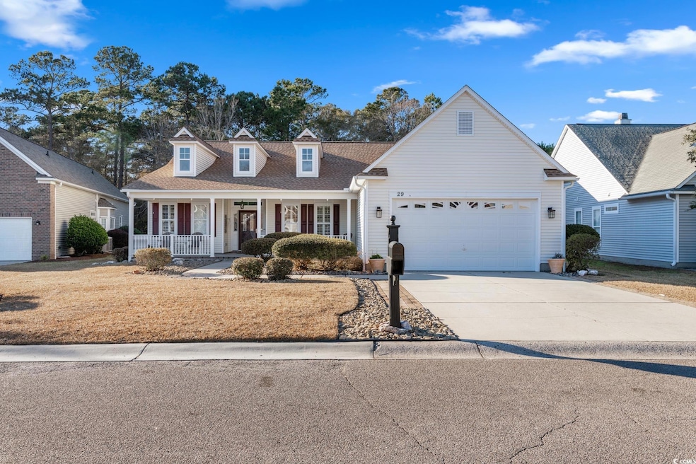 View of front of home with a porch and a garage