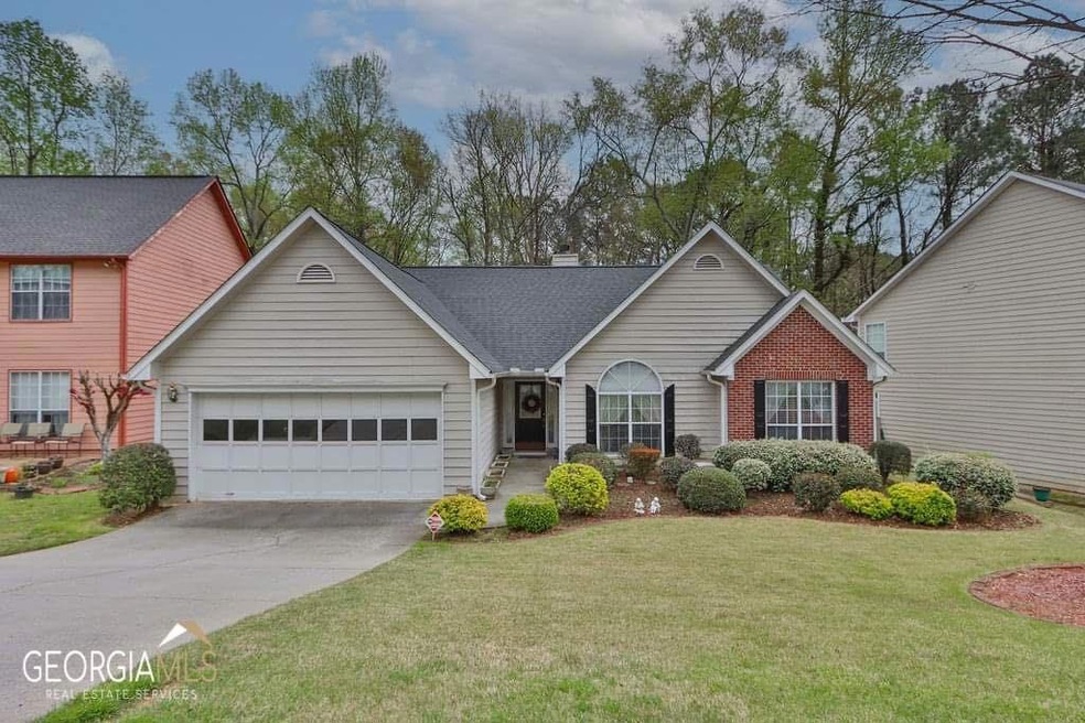 View of front of house with a garage and a front lawn