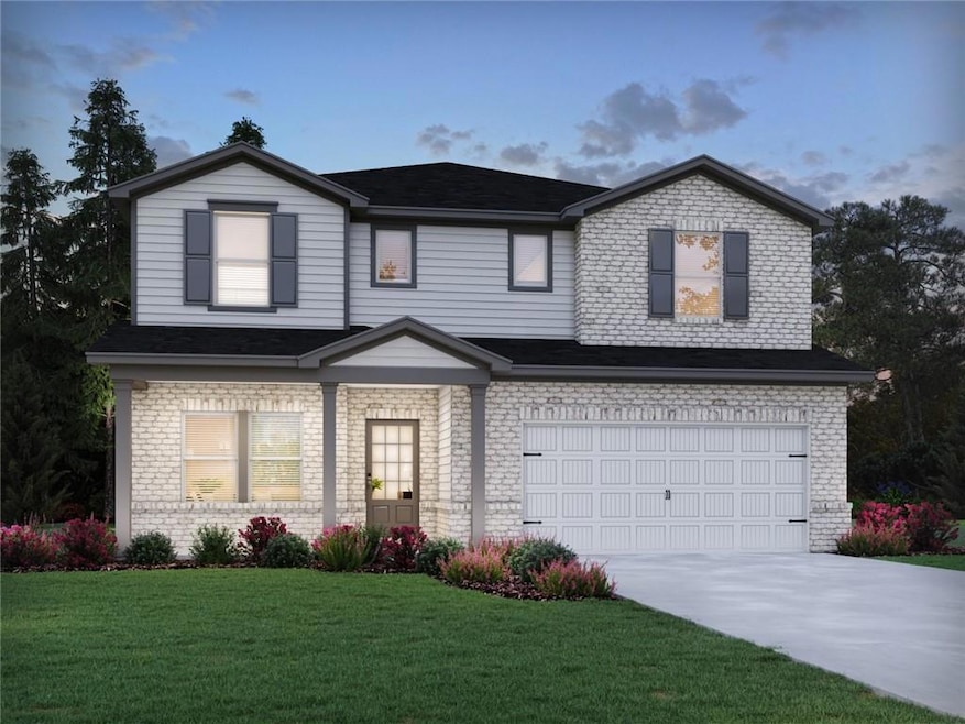 Traditional-style house featuring brick siding, driveway, a front lawn, and an attached garage
