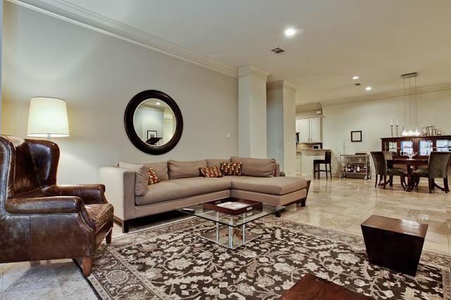 Living room is open to dining area and kitchen. Go