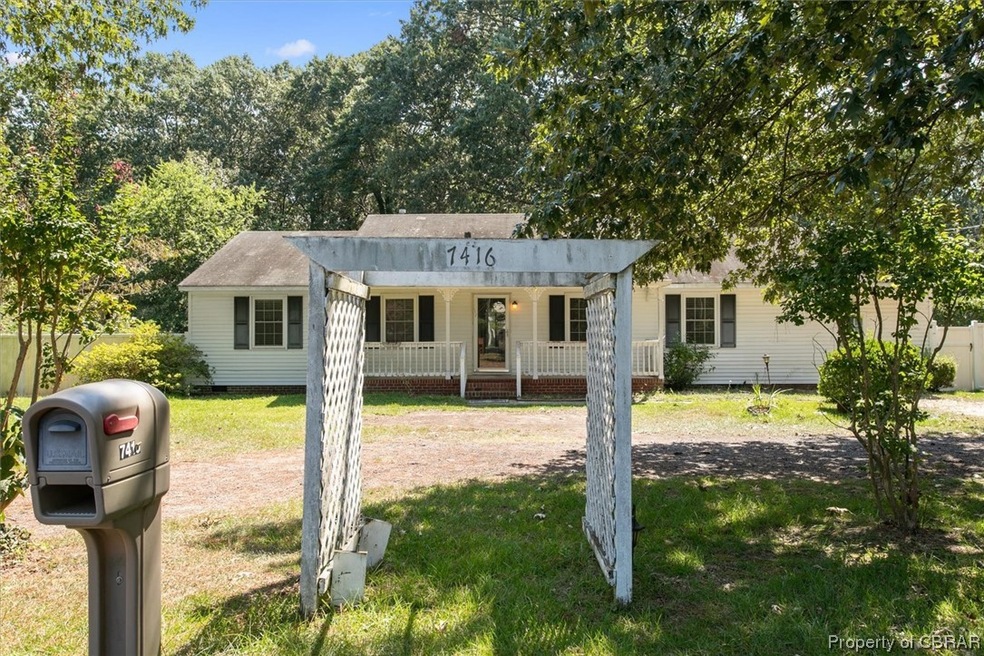 Single story home with a front yard and a porch