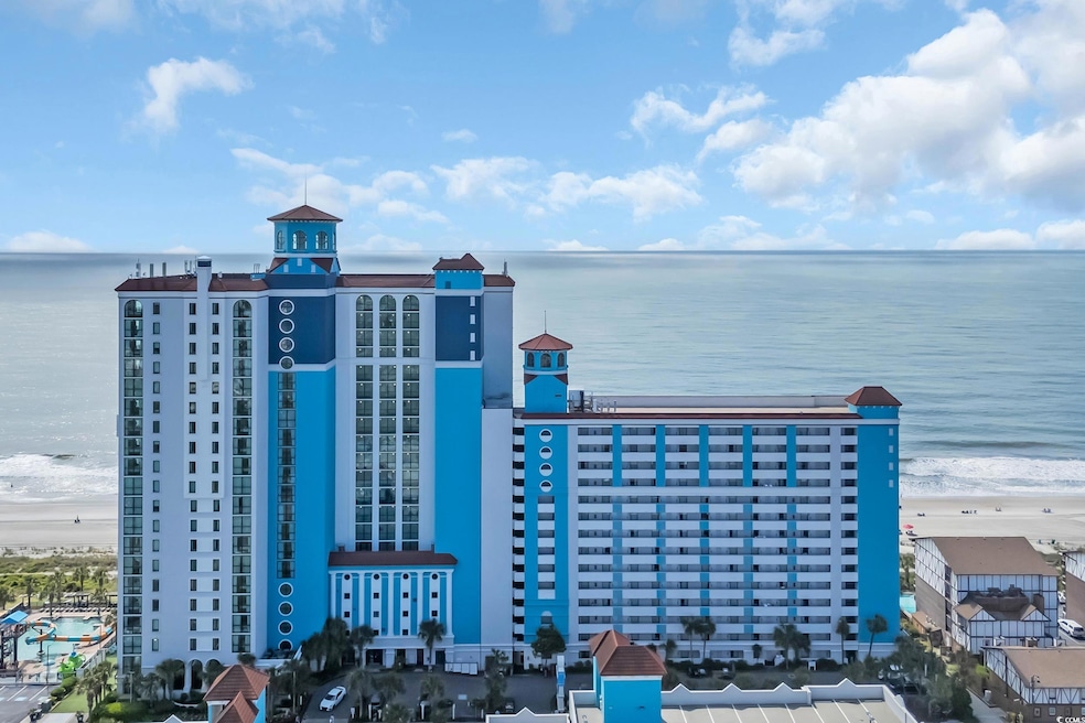 Aerial view featuring a beach view and a water vie