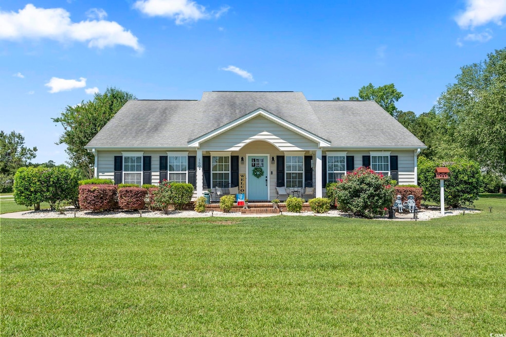View of front of house with a front yard, covered porch, and roof with shingles