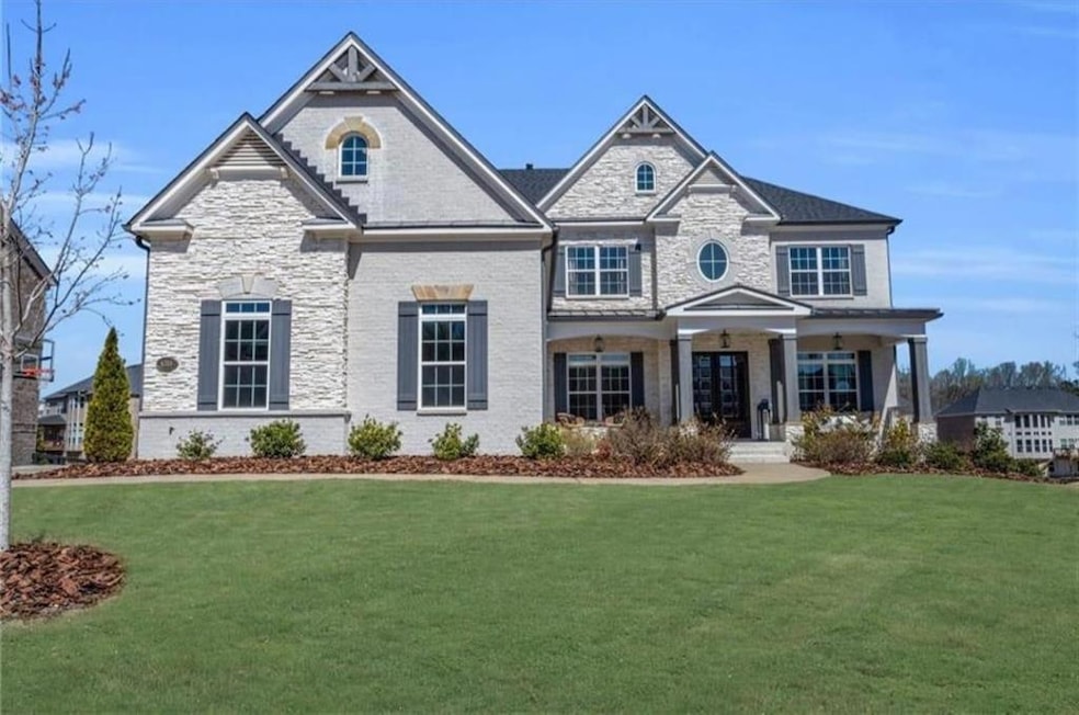 Craftsman inspired home with a porch, stone siding