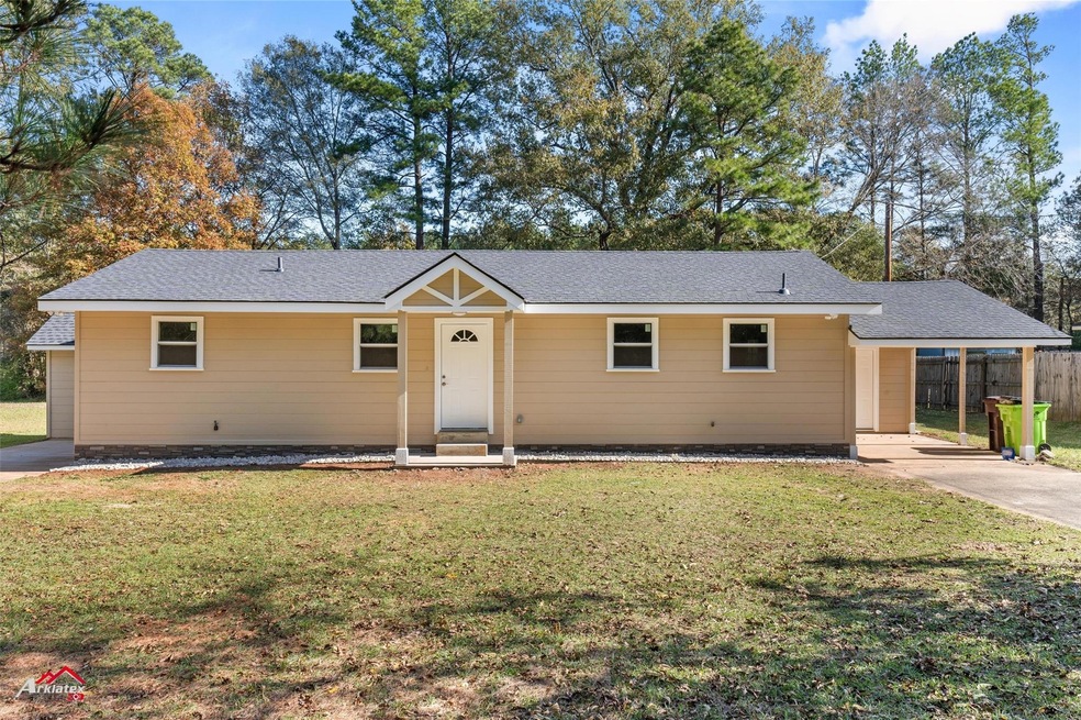 Ranch-style house with a front lawn and a carport