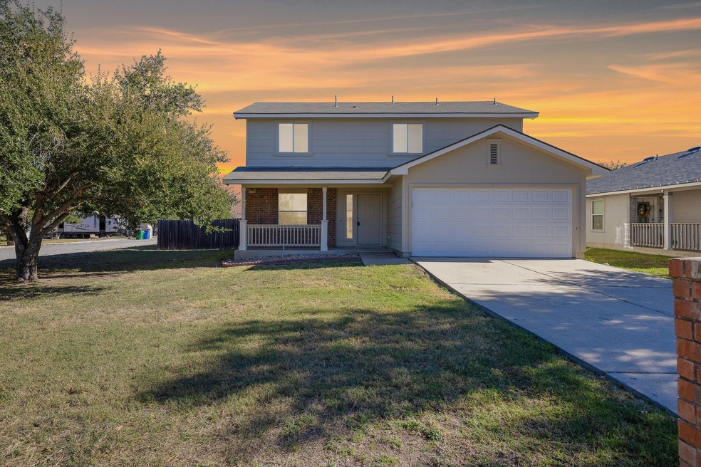Traditional-style home featuring a porch, an atta