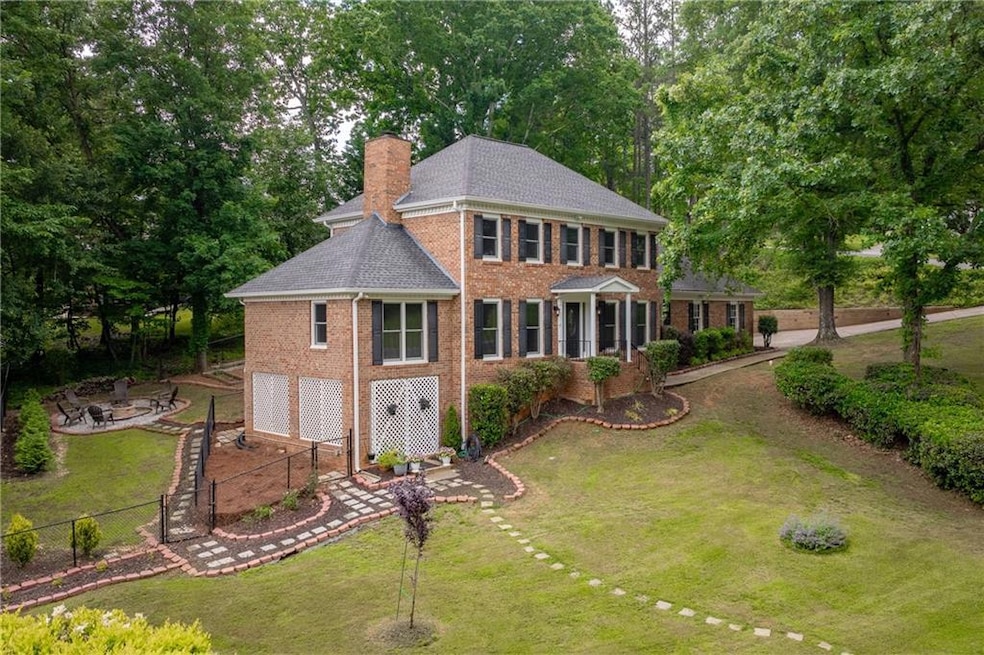 View of front of home with a garage and a front la