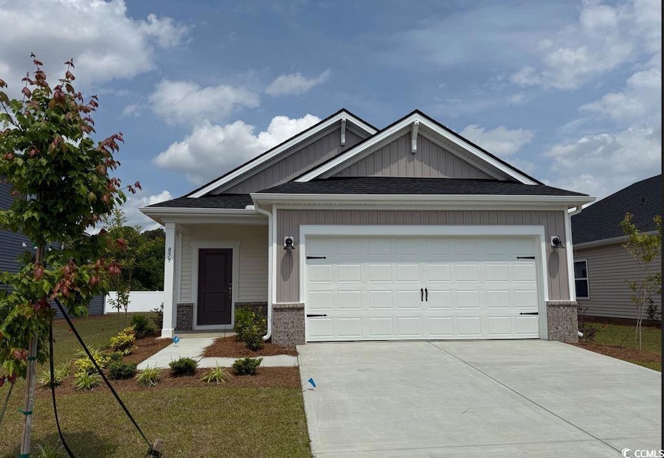 Ranch-style home with concrete driveway, an attach