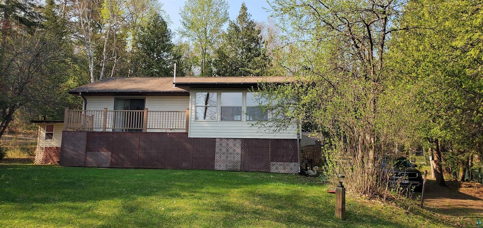 View of side of home with a yard