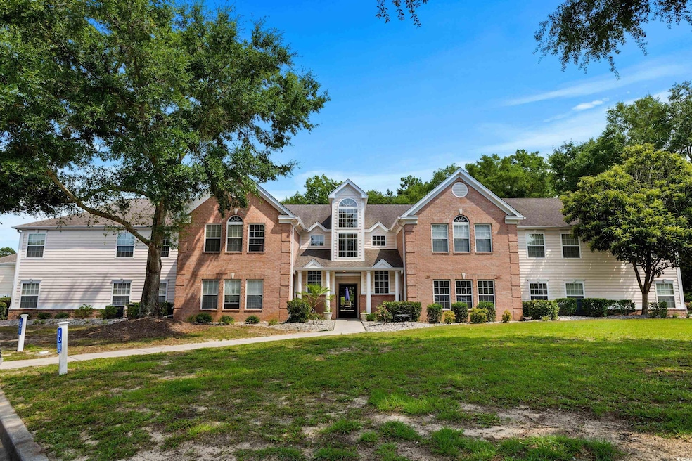 View of front of home with a front lawn and brick siding