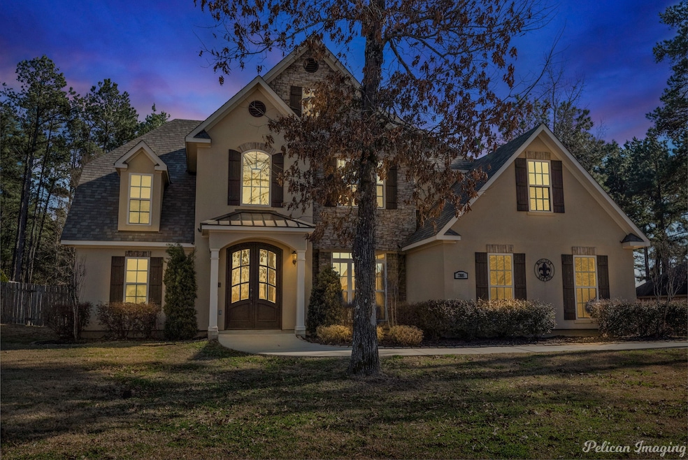 Traditional home with stucco siding and a shingled roof