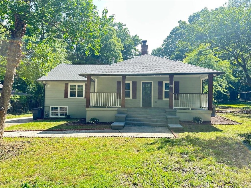 Bungalow-style home featuring a chimney, covered porch, a shingled roof, and a front lawn