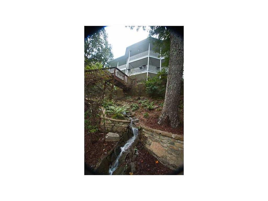 Exterior Back. Gorgeous waterfall transverses the 