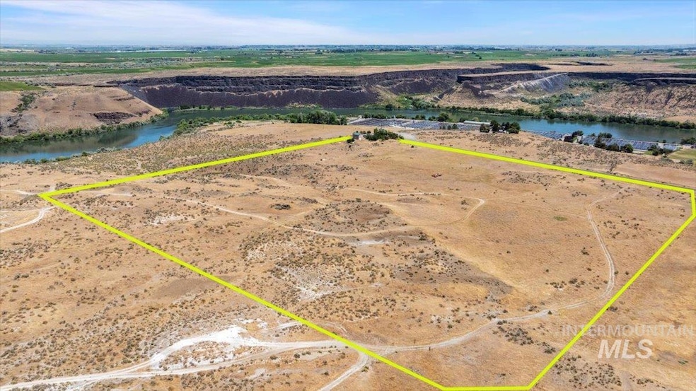 View of rural area with property parcel outlined and a nearby body of water
