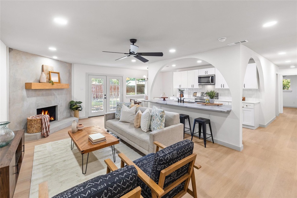 Living room with french doors, light hardwood / wo